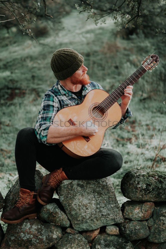 Image, Stock Photo Man with guitar on field