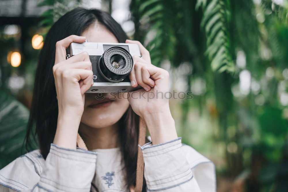 Blonde white woman holding an old VHS tape and playing with it.