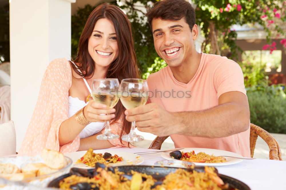 Cute young adult couple taking photo at outdoor picnic