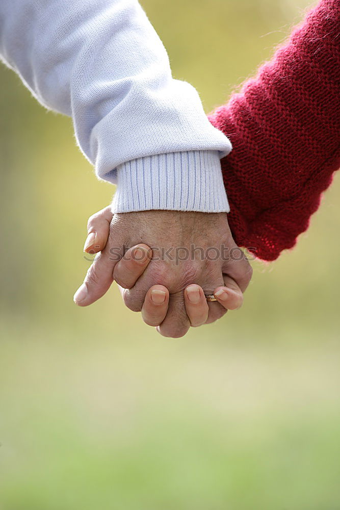 Similar – Baby girl holding finger of senior man hand