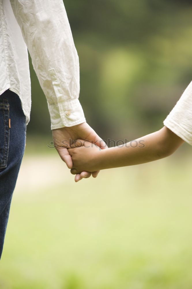 Similar – Baby girl holding finger of senior man hand