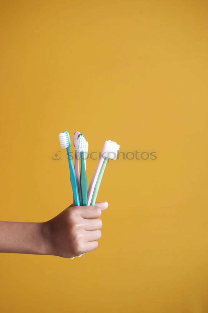 Similar – Image, Stock Photo Forearm and hand with pencil against a yellow background