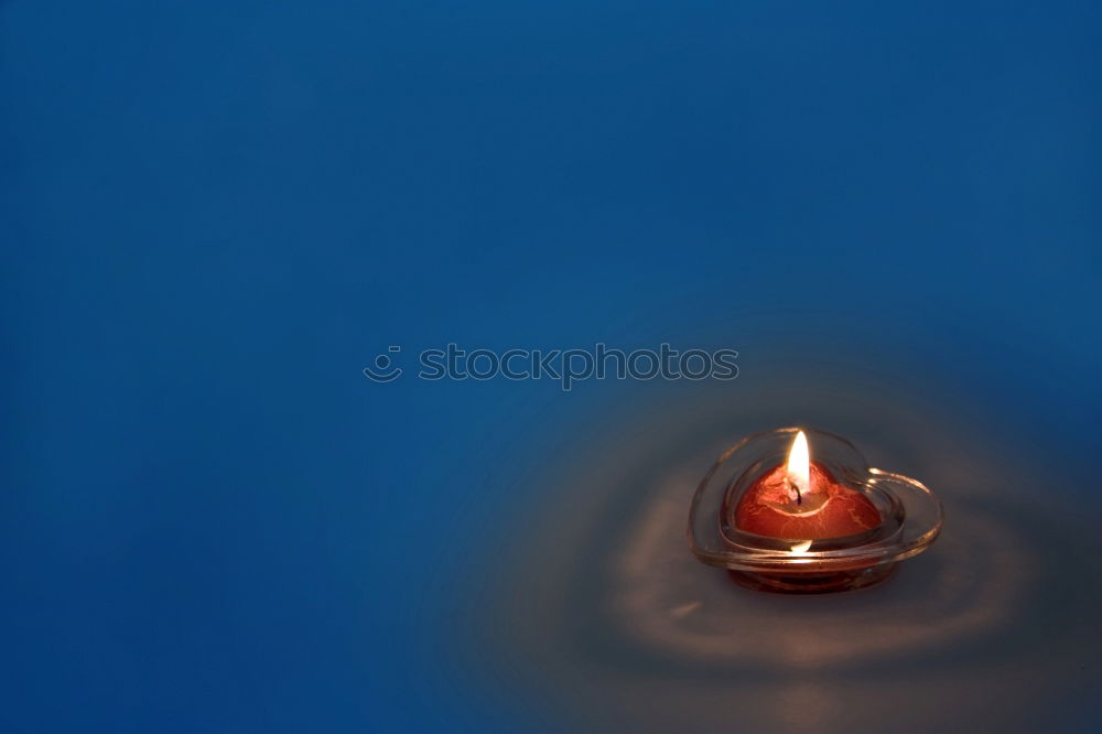 Similar – Image, Stock Photo two red burning candles stand one behind the other in front of a turquoise background