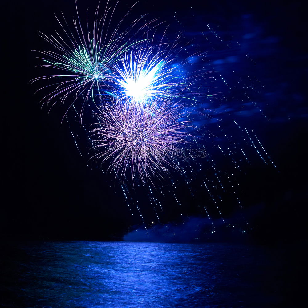 Similar – Colorful fireworks above a lake