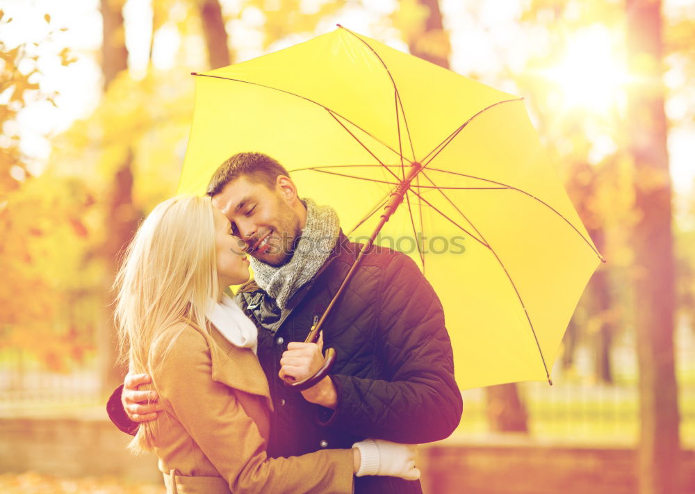 Similar – Young couple looking at each other under umbrella outdoors