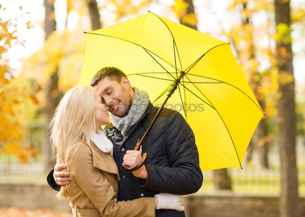 Similar – Young couple embracing under umbrella in a rainy day