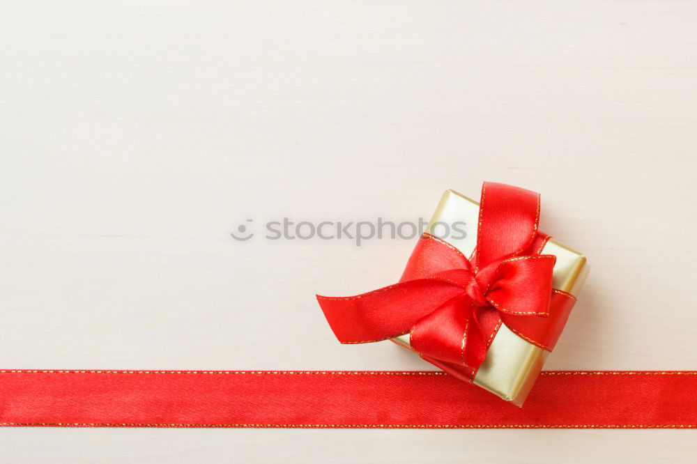 Similar – Gift box wrapped in recycled paper, red bow and tag