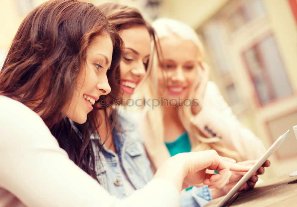 Similar – Image, Stock Photo Two teenagers in white sports shirts using tablet PC in cafeteria. They looking at pad screen