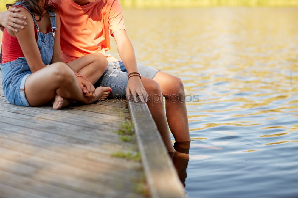 Similar – Young couple under blanket with hot drink kissing outdoors