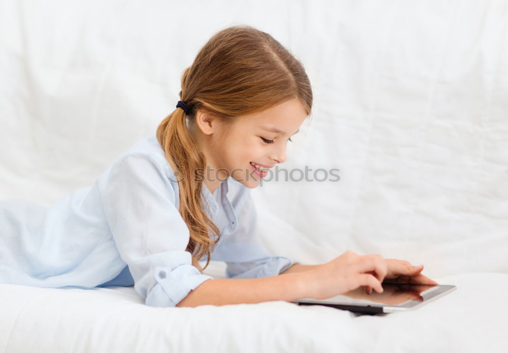 Similar – Little girl using a tablet at home