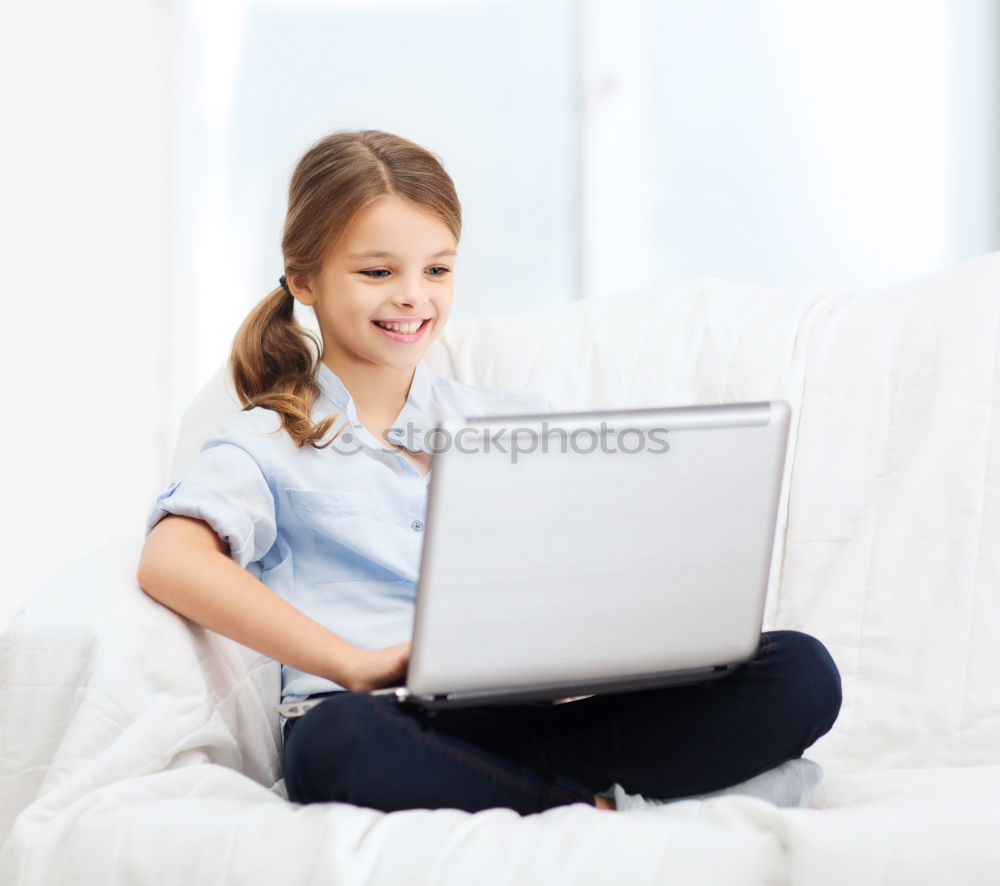 Little girl using a tablet at home