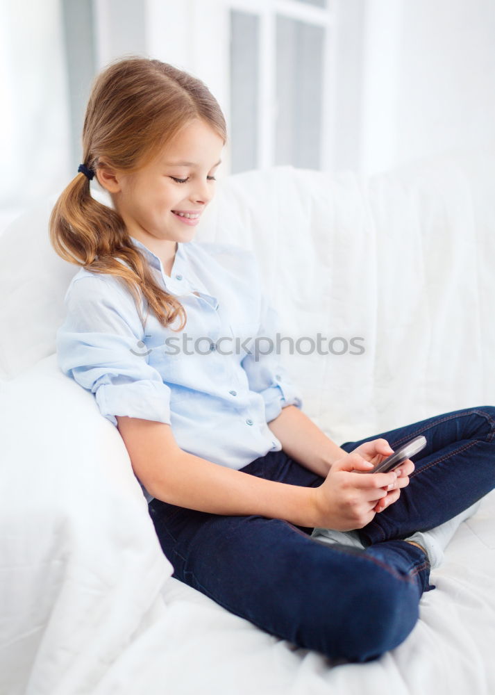 Similar – Little girl using a tablet at home