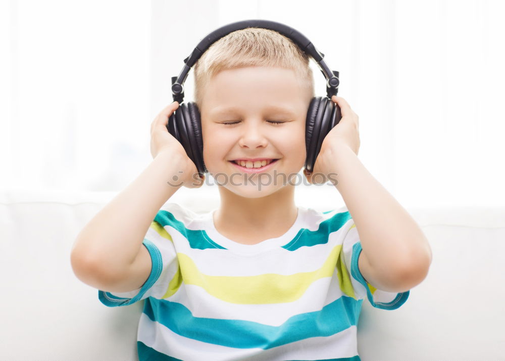 Similar – Child with headphones, listening to music