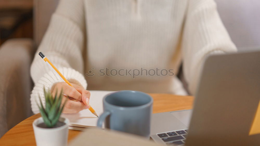 Similar – Woman measuring her own blood pressure at home.