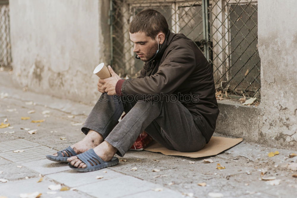 Similar – Young woman sitting on sidewalk in front of abandoned house