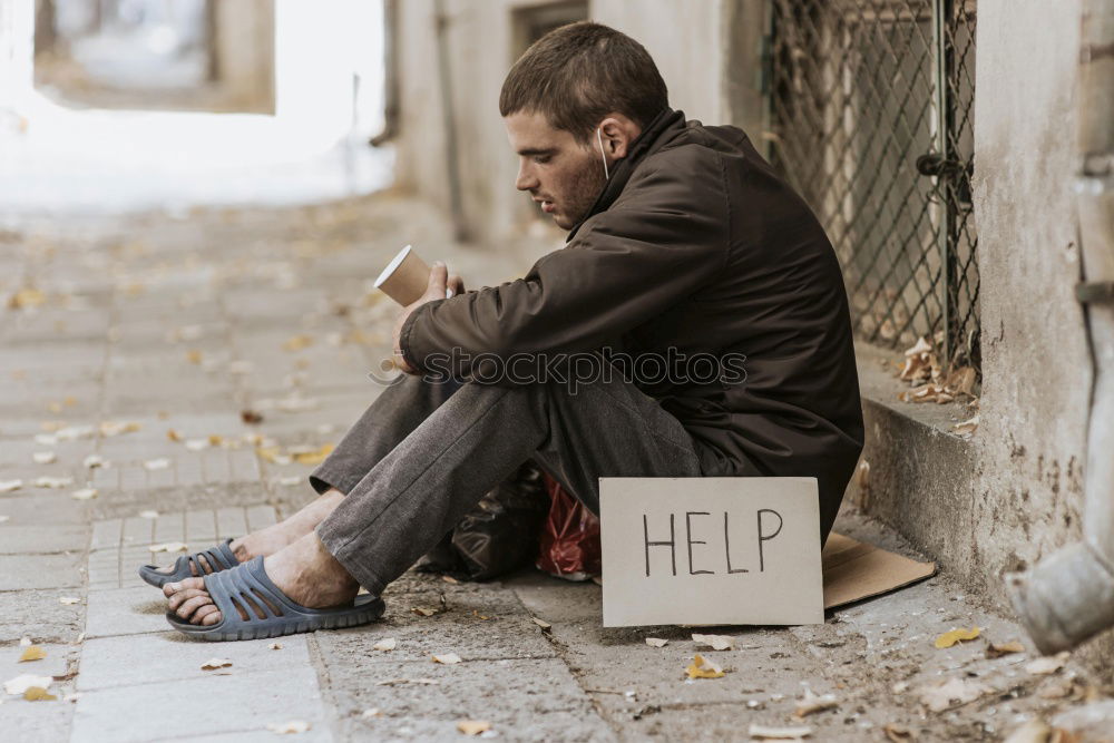 Similar – Young woman sitting on sidewalk in front of abandoned house