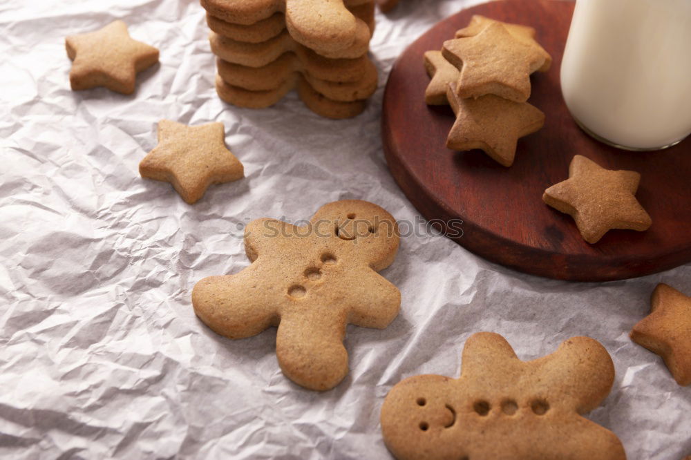 Similar – Cooking Christmas cookies with cookie cutters on a dark table