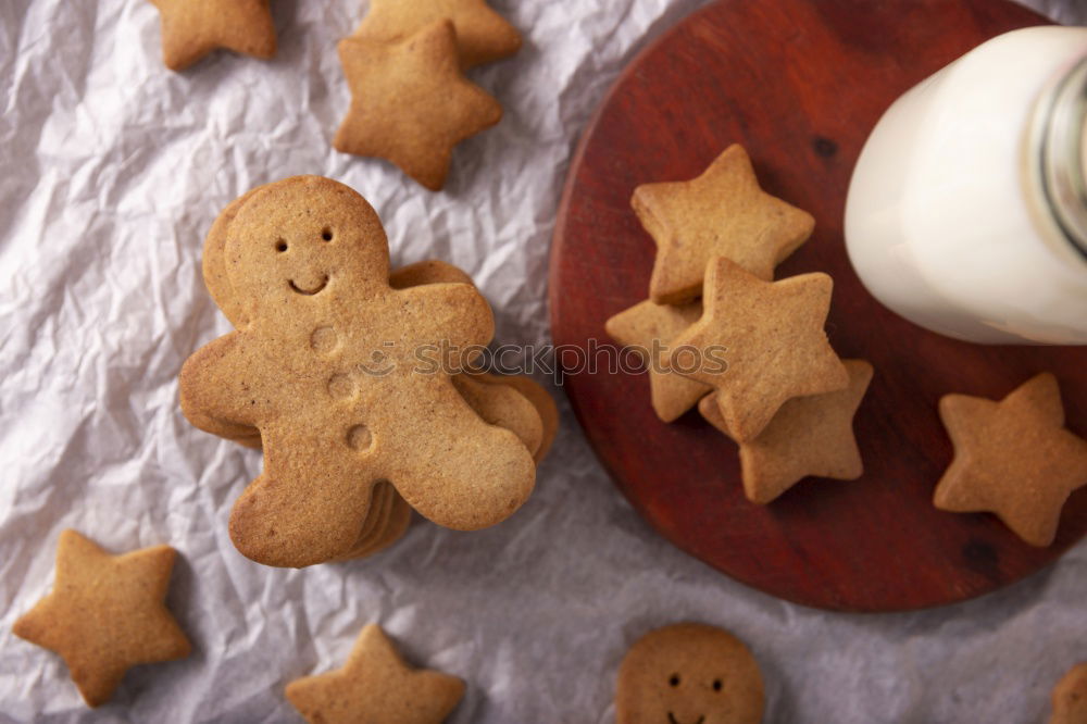 Similar – Cooking Christmas cookies with cookie cutters on a dark table