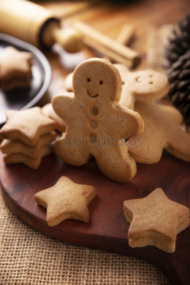 Similar – Cooking Christmas cookies with cookie cutters on a dark table