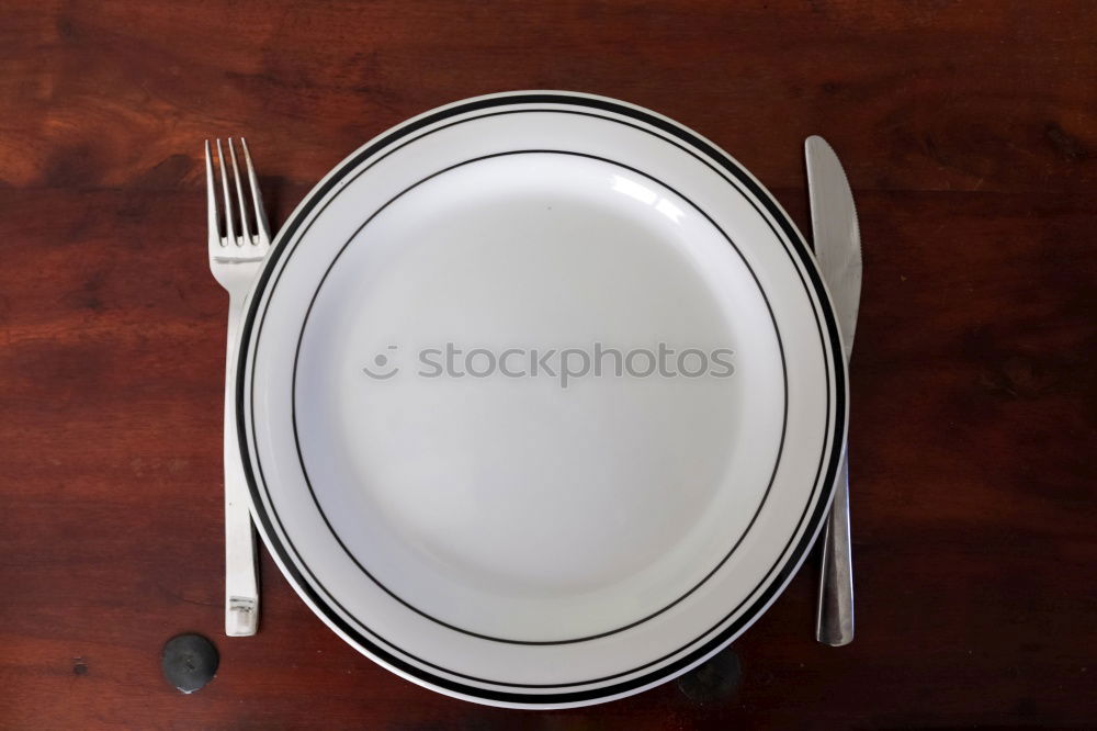 Similar – Half empty white plates, vintage knife and fork