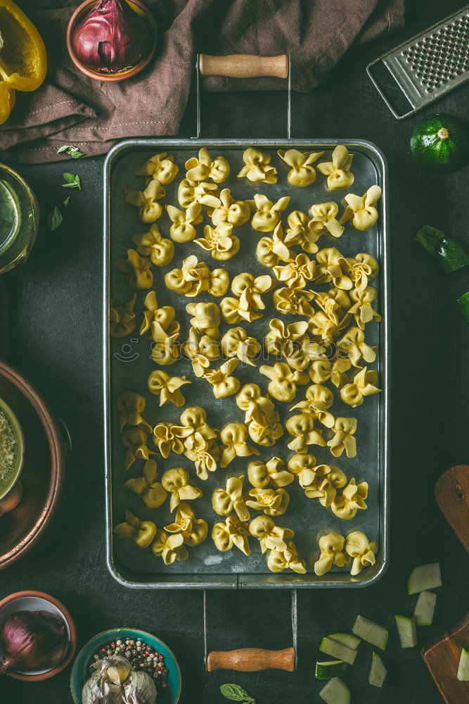 Vegetarian tortellini on the kitchen table with ingredients