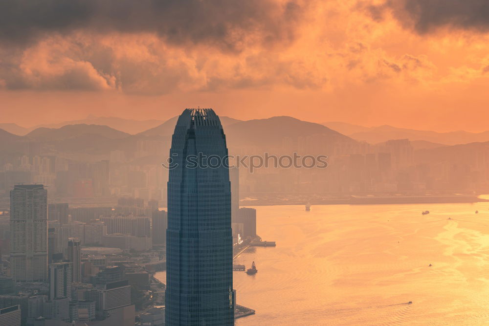 Sunset with boats in front of the Hong Kong skyline