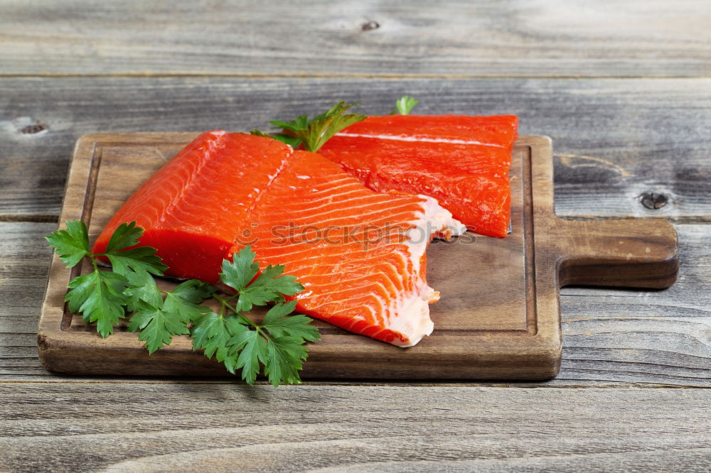 Similar – Fresh raw salmon on a wooden cutting board