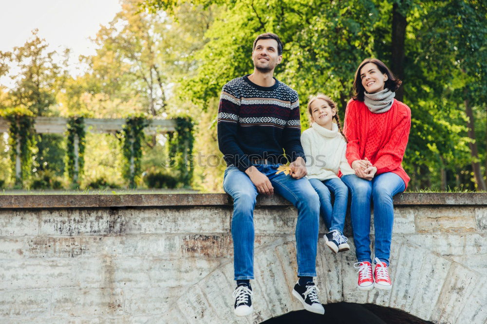 Similar – Family spending vacation time together having a snack sitting on jetty over the lake on sunny day in the summertime