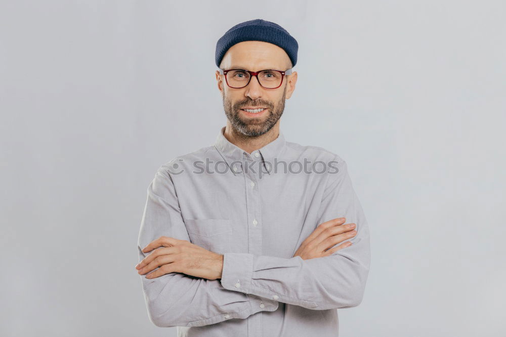 Similar – Man with mustache and glasses standing with crossed arms.