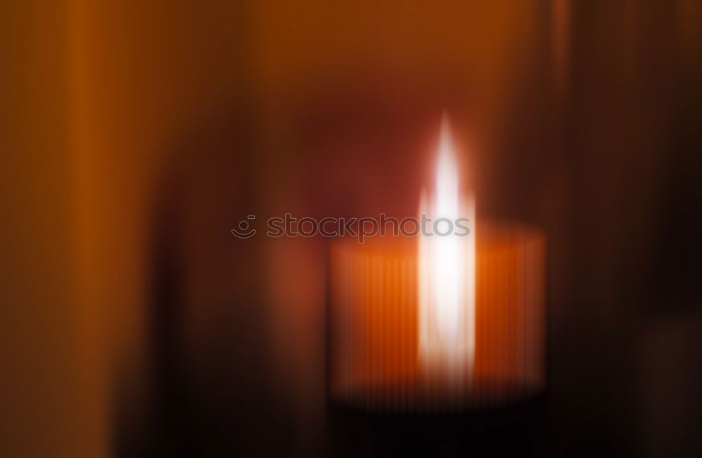 Similar – Image, Stock Photo many church candles with varying degrees of burn stuck in the sand in the dark. selective focus. dripping wax from one candle.