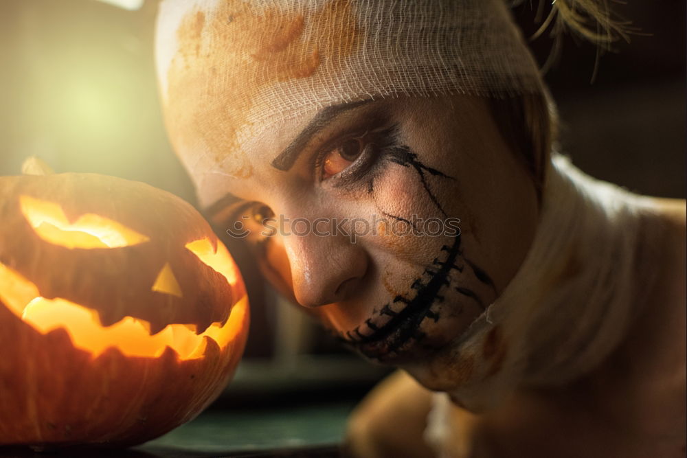 Similar – Image, Stock Photo Happy children disguised decorating a pumpkin at home.