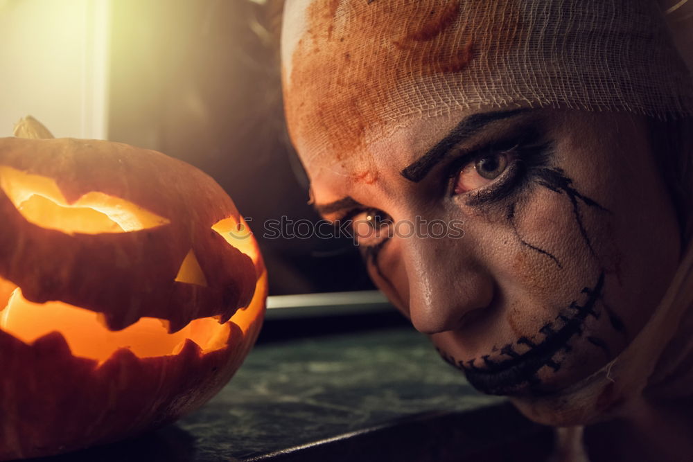 Similar – Image, Stock Photo Happy children disguised decorating a pumpkin at home.