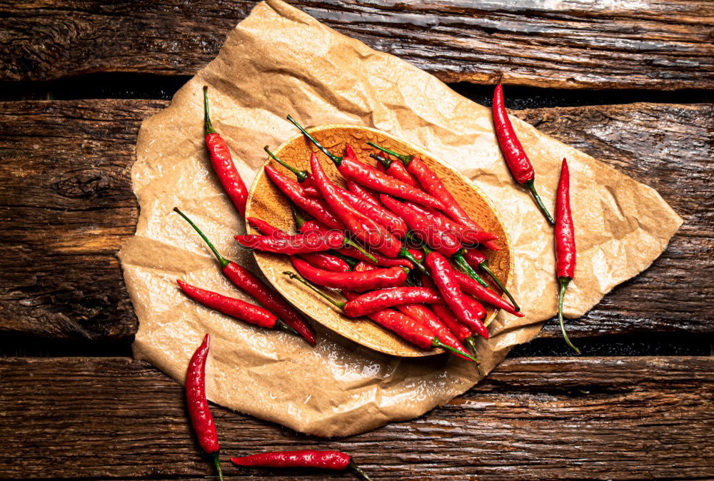 Similar – Image, Stock Photo Red hot chili peppers on a wooden background