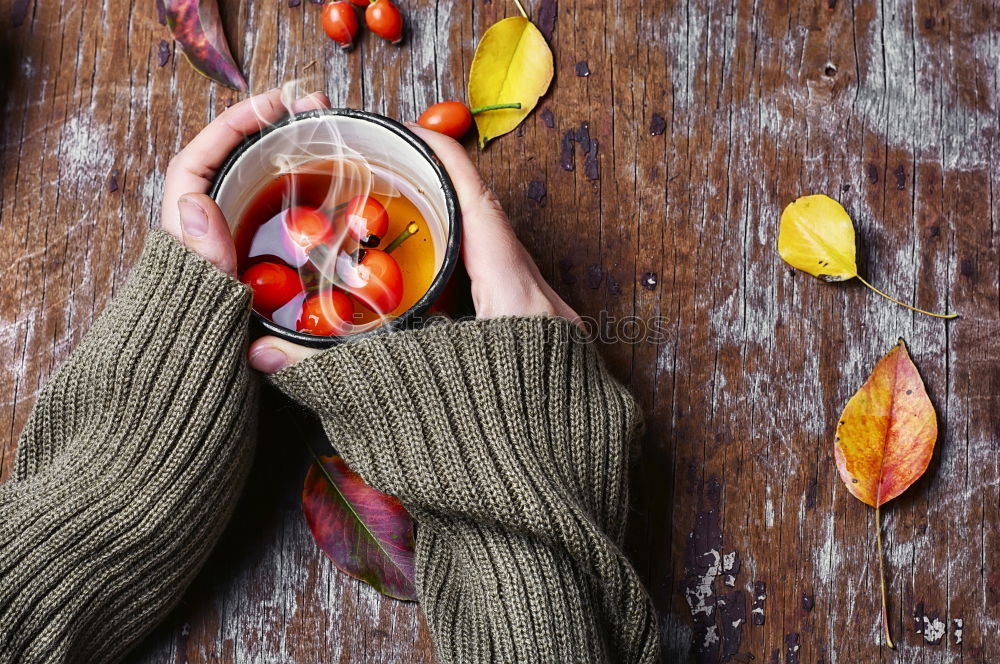 Similar – female hands holding an iron mug with carrot juice