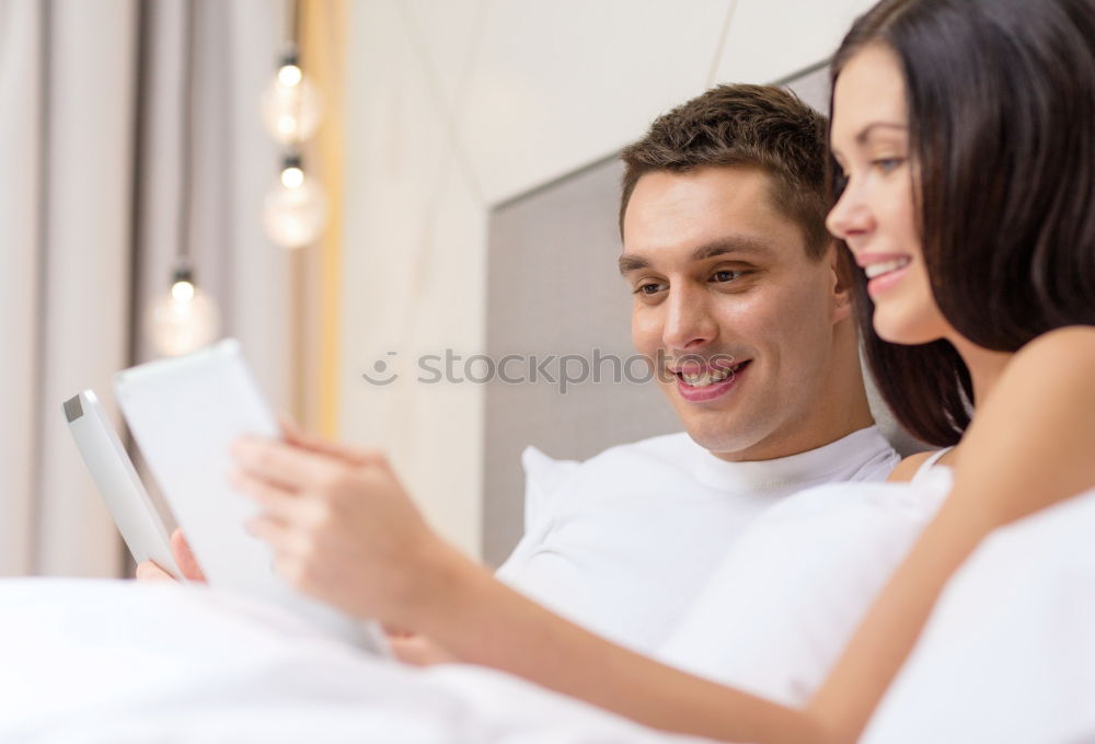 Similar – Image, Stock Photo Couple browsing on online on smartphone at home