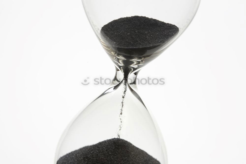 Similar – Hourglass with black sand running out