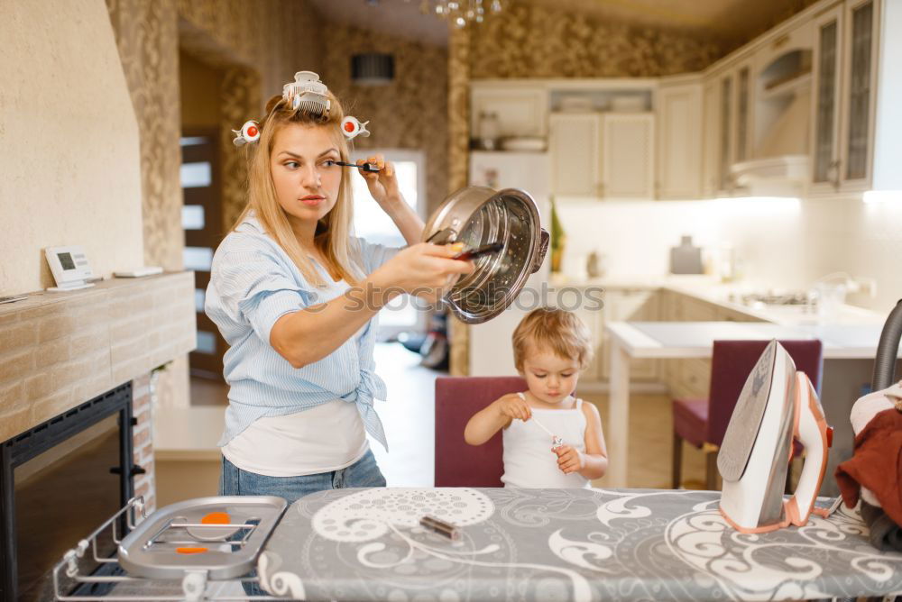 Similar – Image, Stock Photo Little girl cooking with her mother in the kitchen.