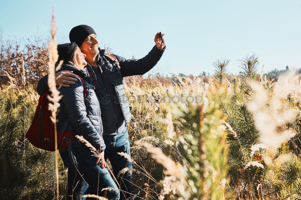 Similar – Image, Stock Photo Couple doing trekking looking with binoculars