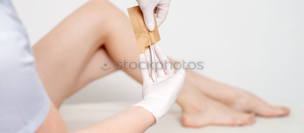 Above shot of white woman holding her legs in shoes