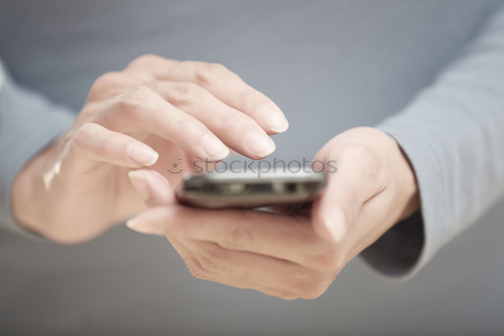 Similar – Close up of hands using smartphone