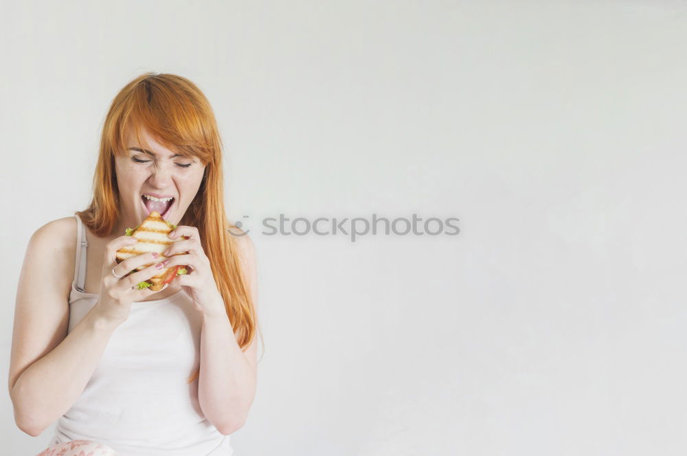 Similar – Young woman with pink hair is licking lollipops