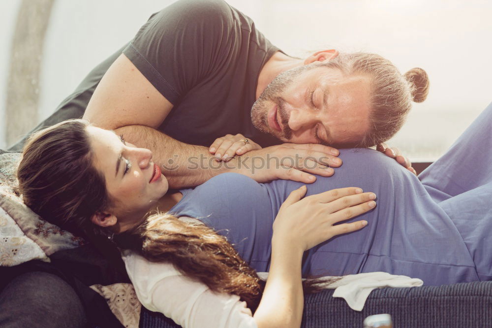 Similar – Couple laying on couch watching TV together