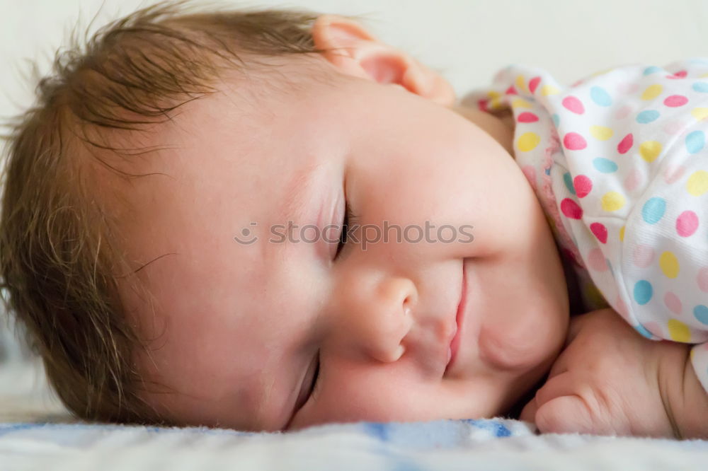 Similar – Adorable baby sleeping wrapped in a red blanket