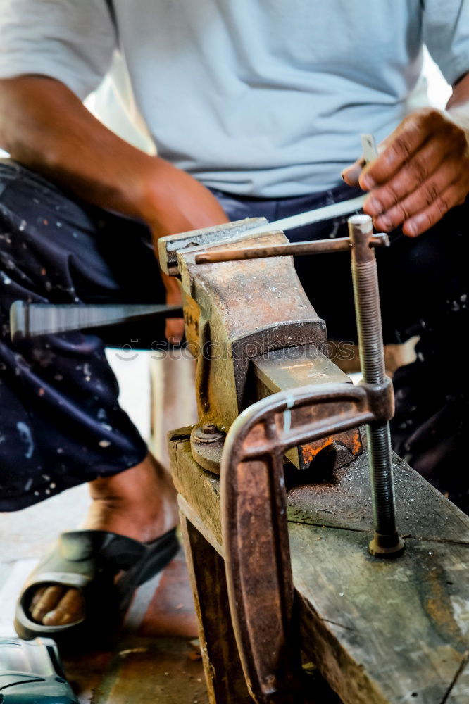 Similar – Carpenter cutting wooden board