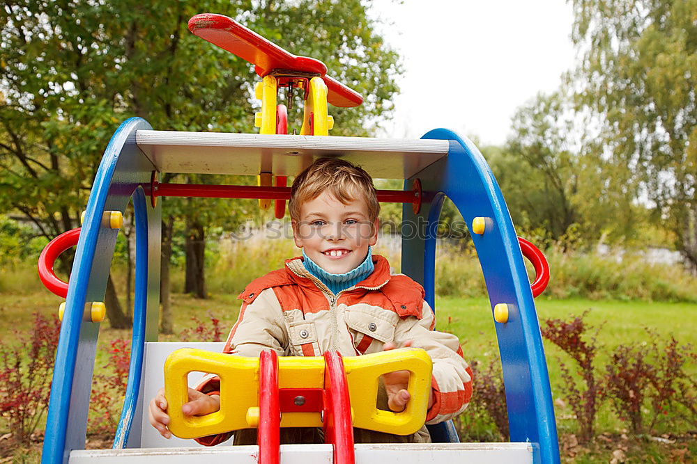 Young boy talking to the phone in a yellow telephone booth