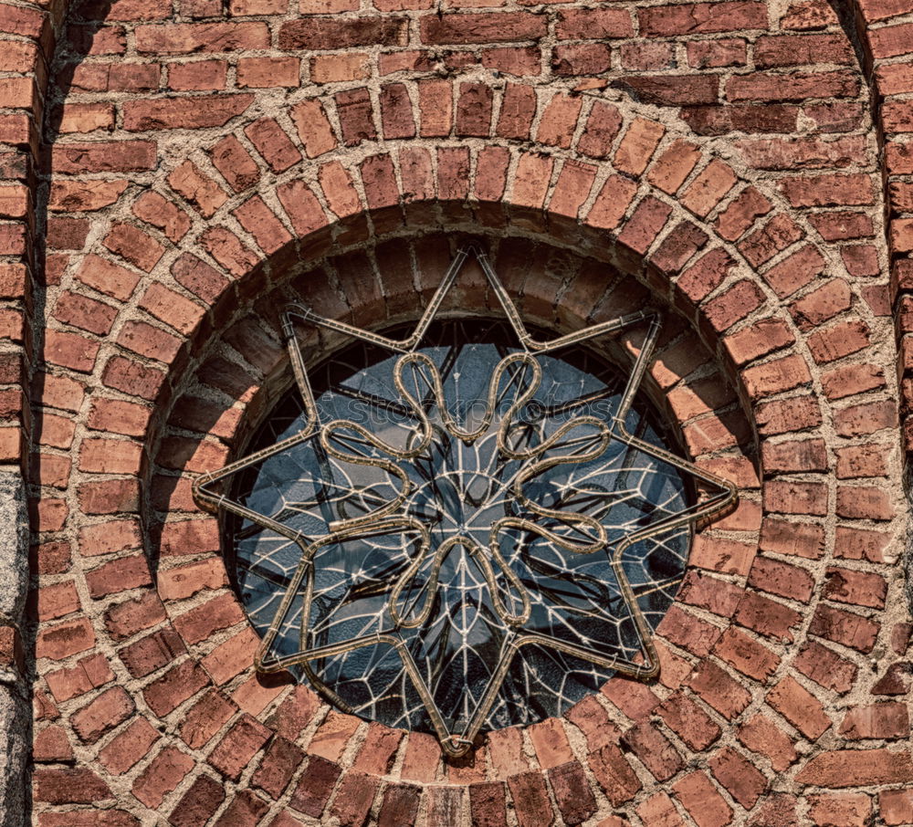 Similar – Gully cover with embedded cobblestones with grey paving stones arranged in a circle in pouring rain