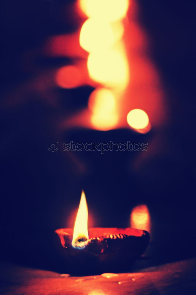 Similar – Image, Stock Photo two red burning candles stand one behind the other in front of a turquoise background