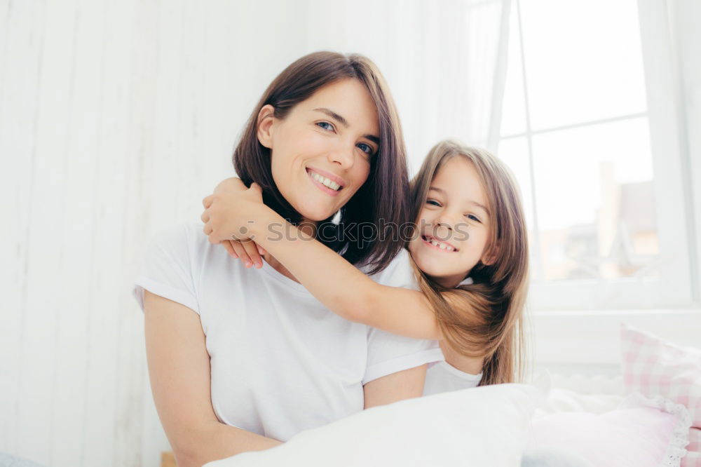 Similar – Two beautiful sisters playing on bed