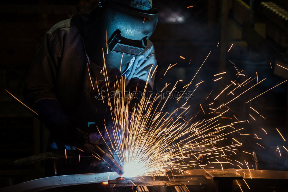 Similar – worker using an angle grinder