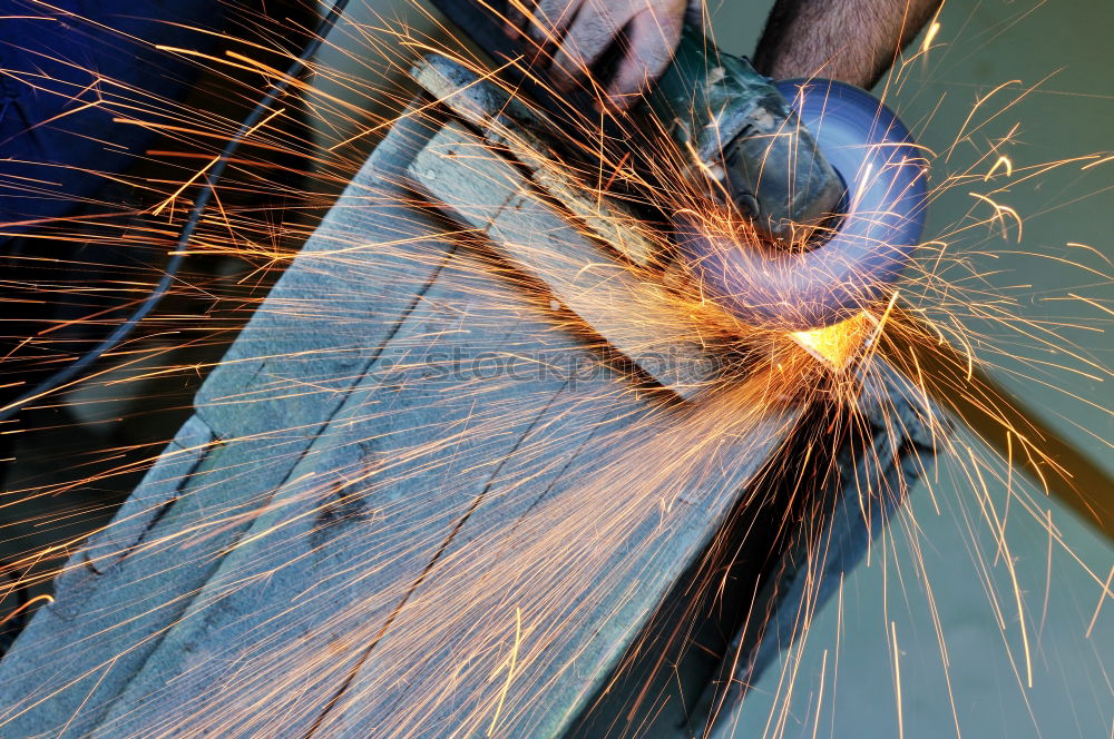 Similar – Mechanic man welding metal material in garage.